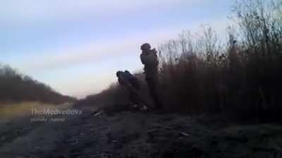 Pro-russian separatist is struggling with the mortar.