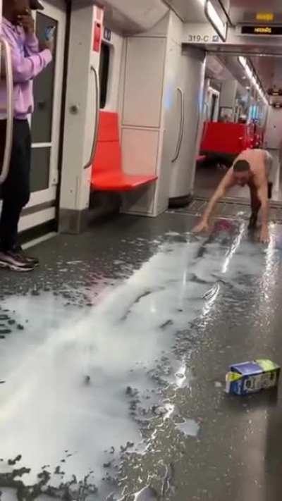 A guy in boxers pouring milk over himself while yelling