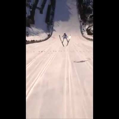 This drone POV of a ski jumper