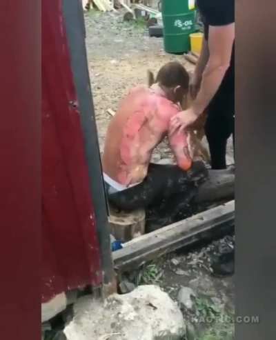 Russian dude is light on fire by a flamethrower, then a woman is harpooned in the neck