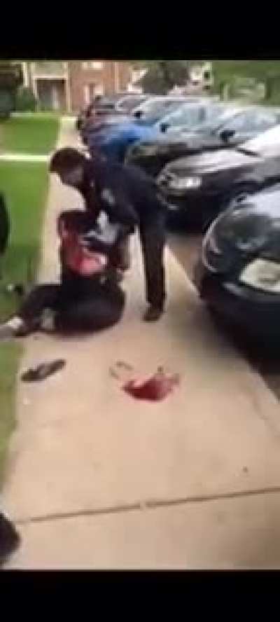 Male officers strip female suspect in public then proceed to smash her head on the concrete.