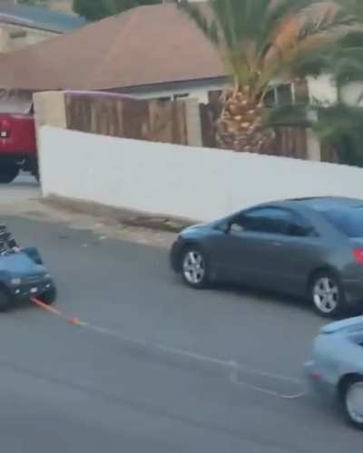 WCGW riding in a Fisher Price pulled by a real car