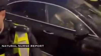 Very angry people surround Bill Gates' car.