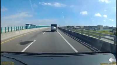 Styrofoam box jumps out and back of the truck, twice