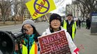 Based yellow-vested asian lady yelling at SJW protesters