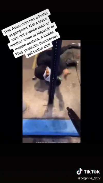 Man protecting his shop from looter