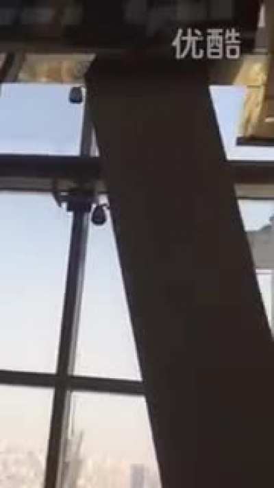 Shanghai Window Cleaners Blowing in Strong Winds (92 floors up)