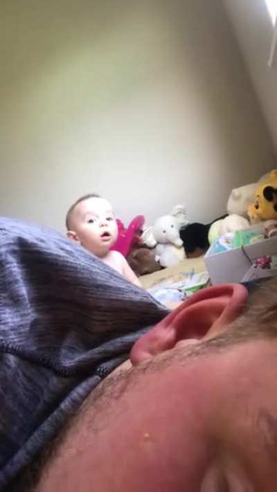My son discovering the camera, but with something else in mind