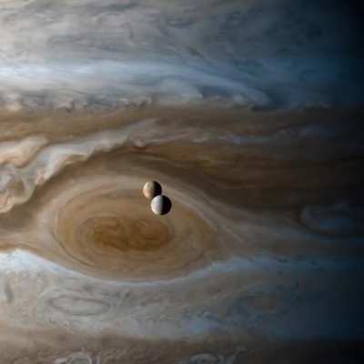 Europa & Io moons orbiting Jupiter, captured by the Cassini space probe