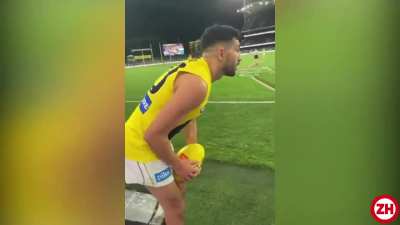 Spectators taunt a football player to miss. But he nails the goal.