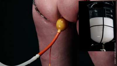 Sparkle’s asshole is exposed by the stainless steel chains that hold her hips apart and spread her cheeks. The crotch of her latex bodice is held to one side by a ratchet pull and I take advantage of the wide open exposure of her asshole to get it plugged