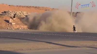 Car disappears into the dust and sand