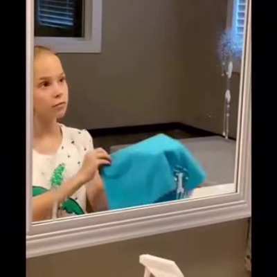 Girl cleaning her mirror