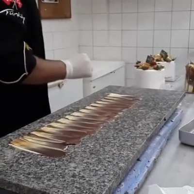 A pastry chef decorating a cake
