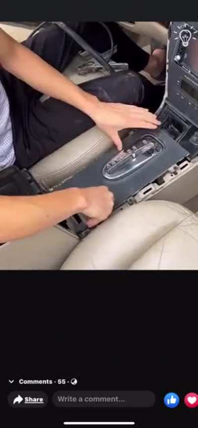 A man fixes his car’s transmission