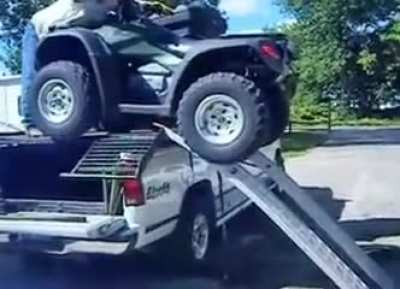 Guy loads two ATVs onto his truck