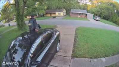 Guy jumps onto woman’s car while running from dog