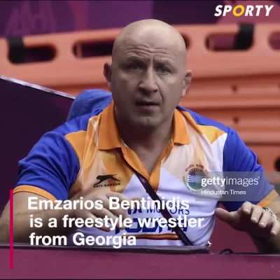 Wrestling Coach celebrates victory with student after match ends.