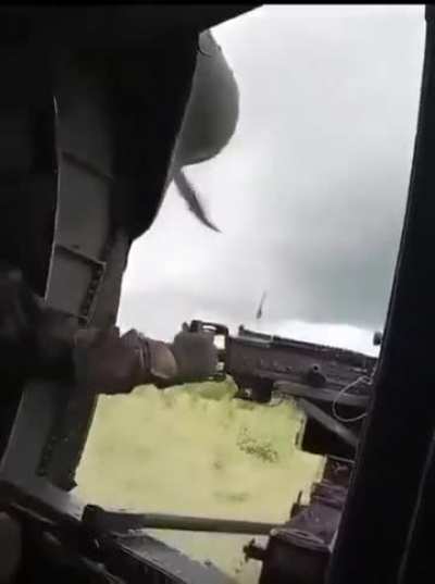 Colombian Army chopper repelling enemy fire while landing