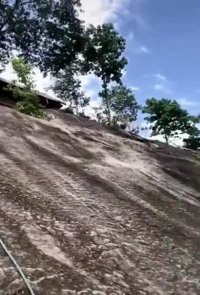 How this monk is able to climb this mountain side without using a rope