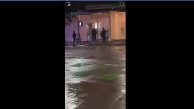 Police officers destroying buildings.