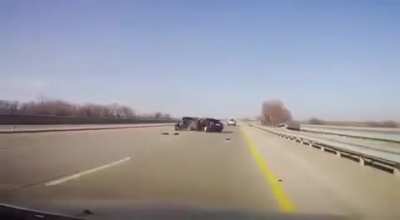 Maybe get off of the highway before you decide to change your tire?