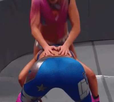 Alexa bending Bayley over