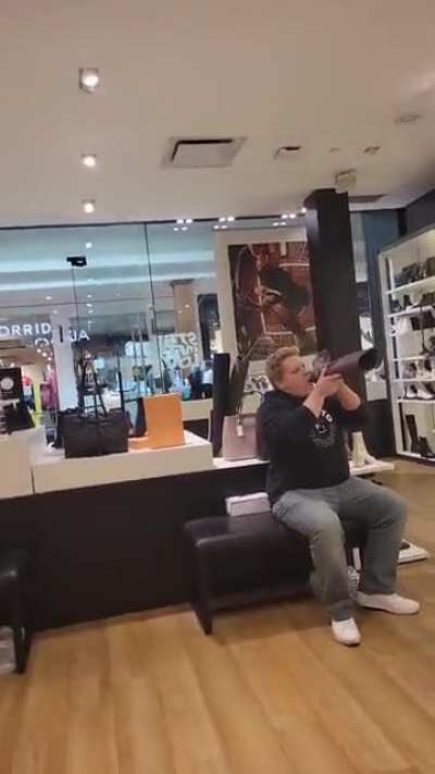 Guy licking a boot vigorously in a shoe store in Kitchener Ontario
