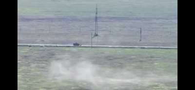 Russian turtle tank under fire by artillery or drones.