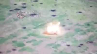 Drone footage of two Russian soldiers on motorbikes driving over a mine while traversing a field to assault a Ukrainian position.