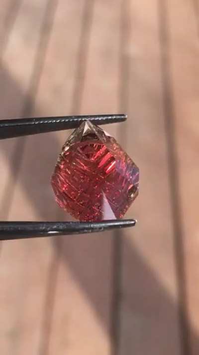 a dichroic 13 carat Oregon Sunstone that I cut recently in fantasy design... it displays a beautiful and bright red with some green on the edges... got to love Oregon Sunstone