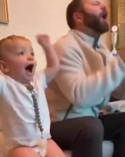A little boy realizes he cheered for the wrong team and quickly fixes it