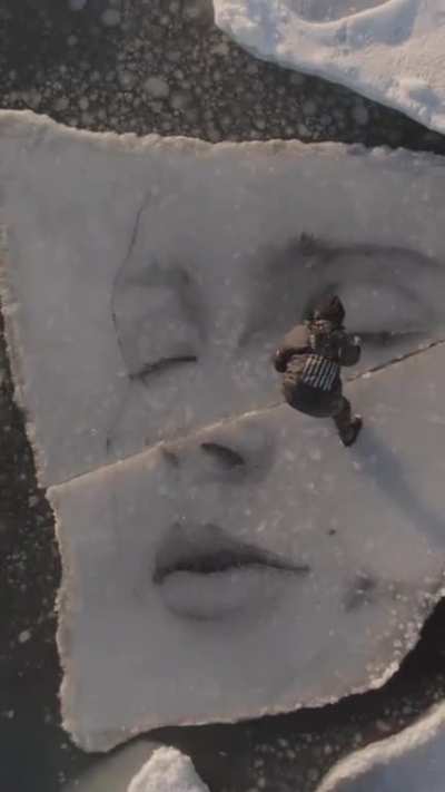 Artist drawing on broken iceberg