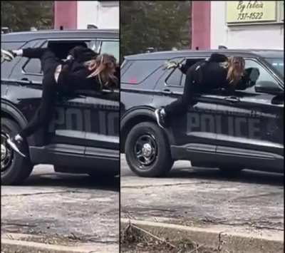 Handcuffed Woman Squeezes Through Partially Open Police Car Window and Flees on Foot in Muskegon Heights, Michigan, United States.