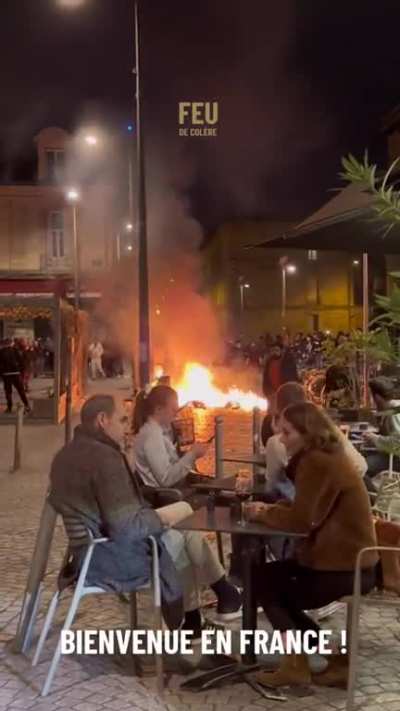People dining at a cafe while the French pension reform take place
