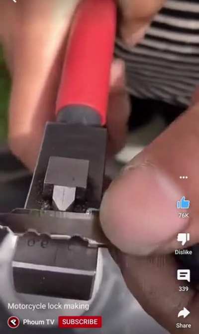 This locksmith making a key for a motorcycle