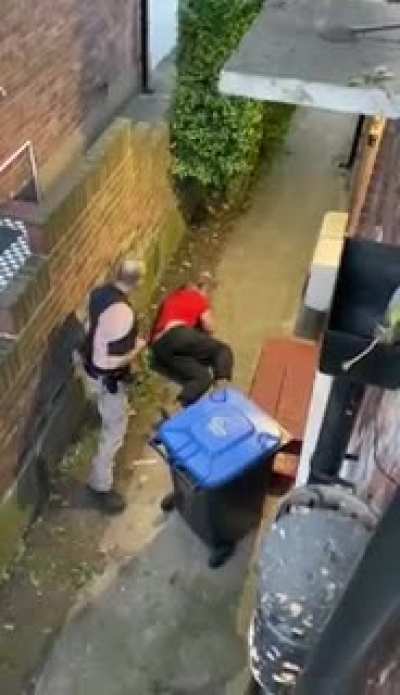 Neighbours fight over Christian cross on gate, ends up with the aggressor knocked out... wife has husbands back on the phone, ride or die.