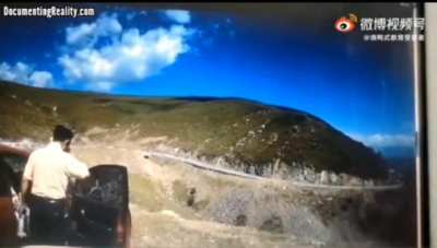 Car rolls off large hill with a passenger riding shotgun