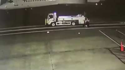 [LFO] Truck Driver Browsing His IPad Runs Over Ramp Agent Guiding an Airplane