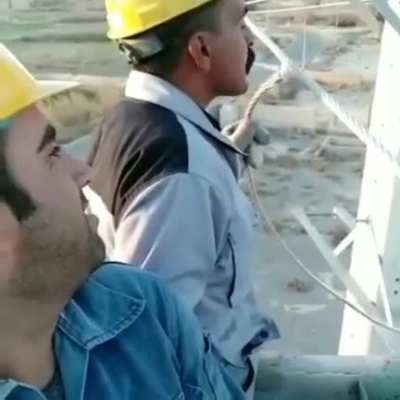Electrician fires a cigarette from a high-voltage line