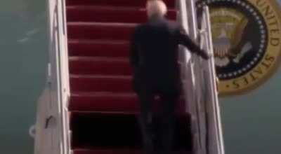 Biden falls off stairs