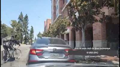 Man screams racial slurs at biker and then gets into a crash