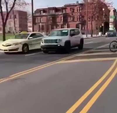 Bike plays chicken with oncoming cars