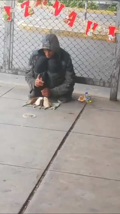 Homeless man teaching tricks to his pet mice