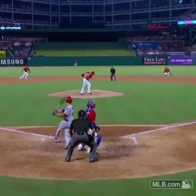 A pitcher making an impressive behind the back catch