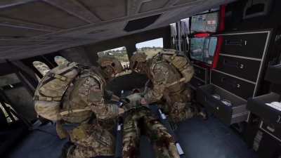 Medics render aid to CAT Alpha while en route to field hospital