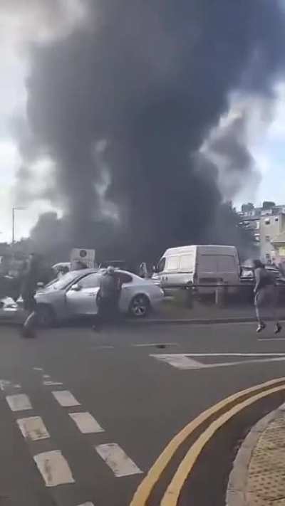 Rioters in Hull, UK destroy a man's car and drag him from it.