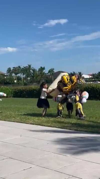 Bumblebee getting knocked down by a bunch of kids while parents watch