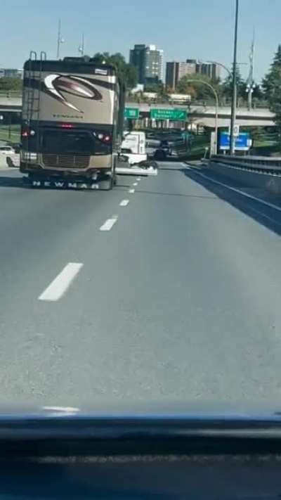 RV driver with his luggage door hanging out