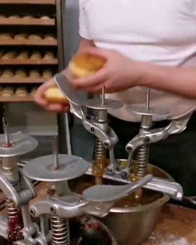 Filling donuts like its his job. Wait...it is.